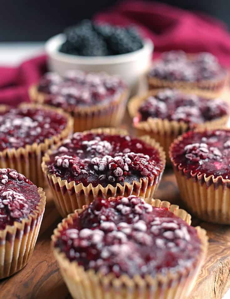 blackberry cheesecake muffins on a cutting board