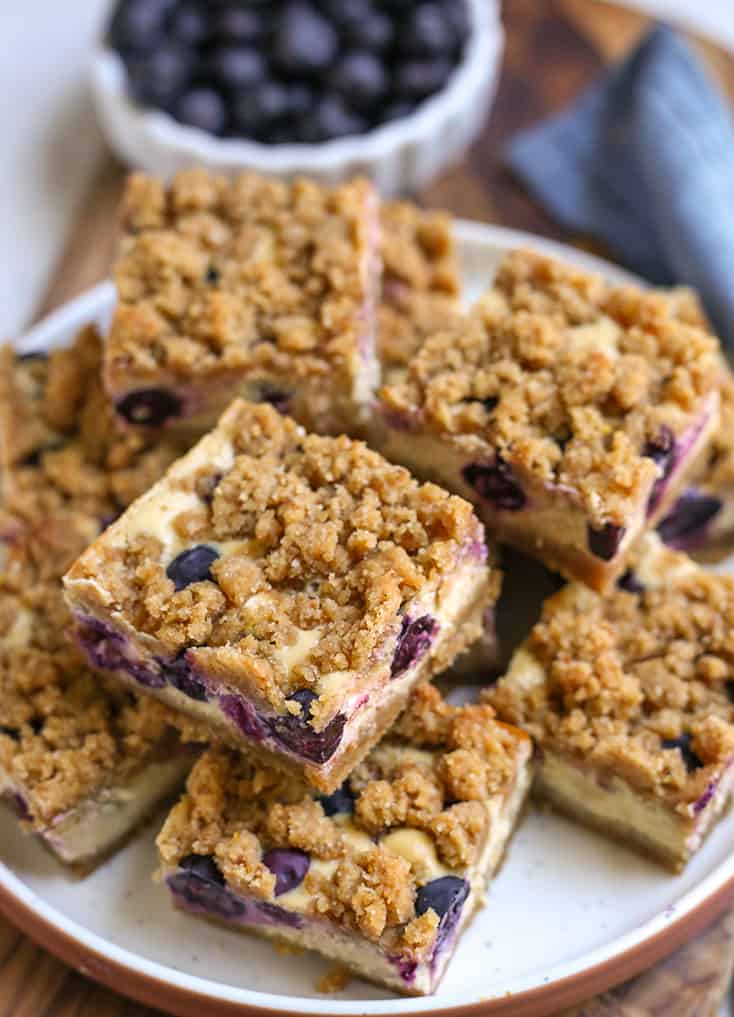 blueberry cheesecake slices stacked on a plate 