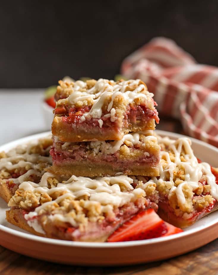 stack of paleo vegan strawberry rhubarb pie bars on a plate 