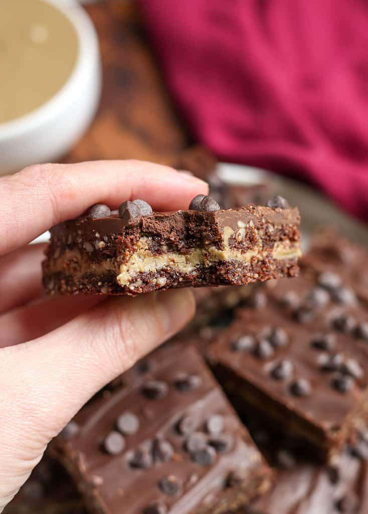hand holding a paleo double fudge bars showing the layers 