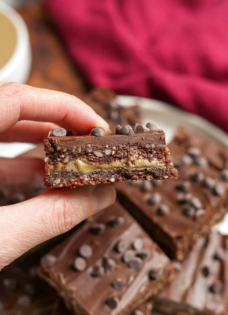 hand holding a paleo fudge bar with the layers showing 