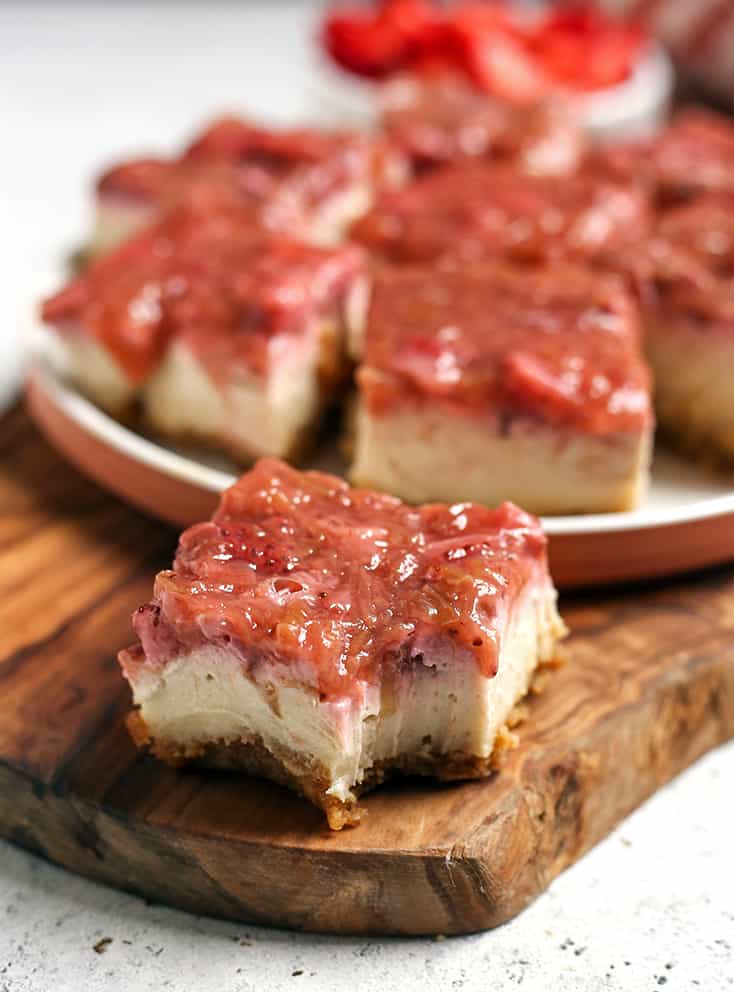 close up of paleo vegan strawberry cheesecake bars with a bite taken out of it 