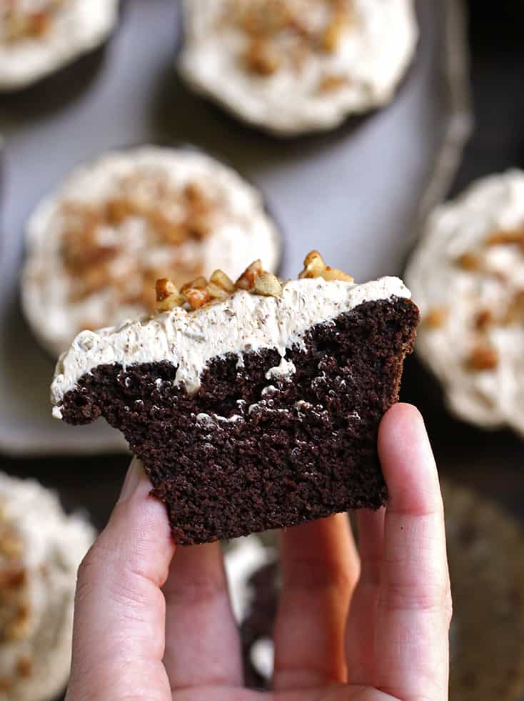 hand holding a grain free bourbon butter pecan cupcake 