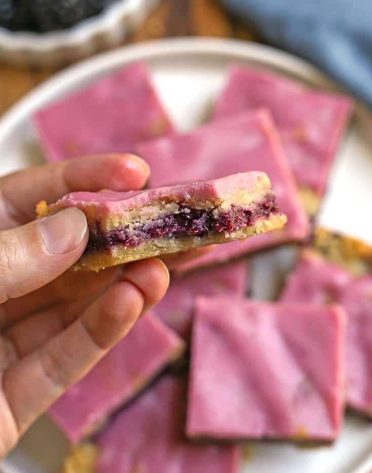 hand holding a paleo pop tart bar with a bite taken out of it 