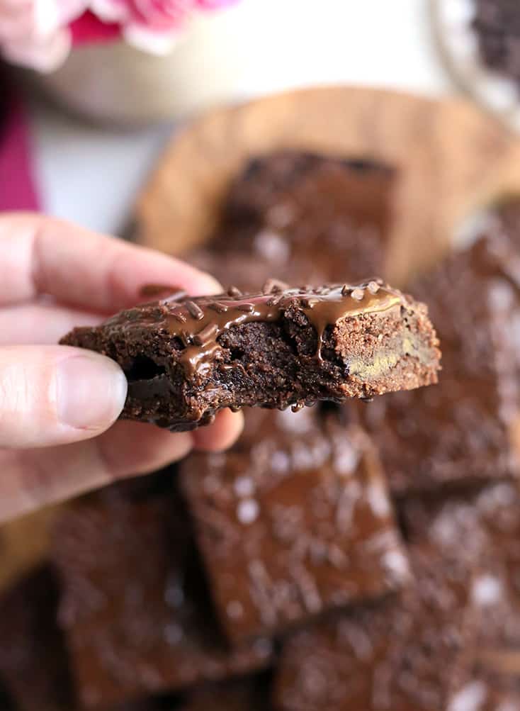 hand holding a vegan chocolate pop tart bar with a bite taken out of it 