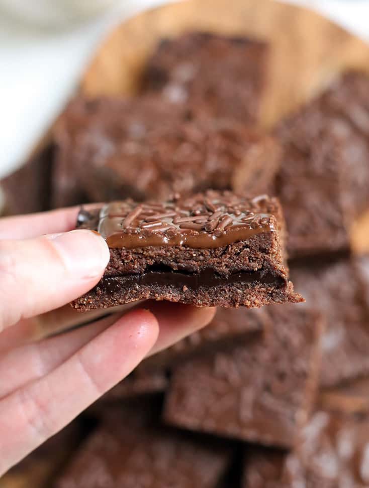 hand holding a chocolate fudge pop tart bar showing the layers 