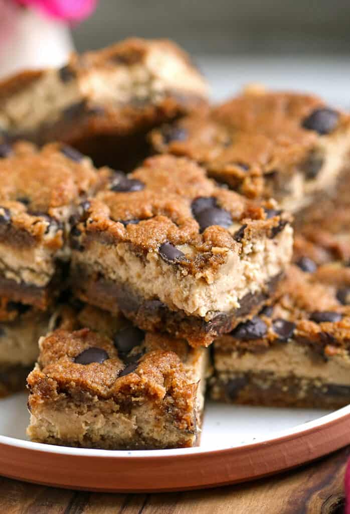 close up view of chocolate chip cookie cheesecake bars 
