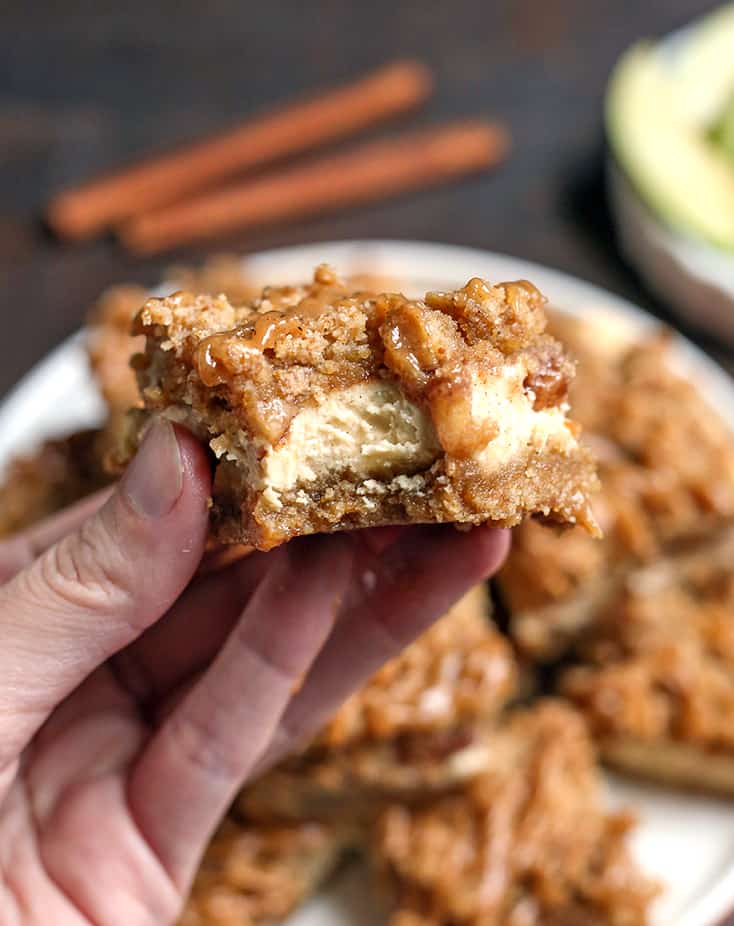 hand holding paleo caramel apple cheesecake bars 