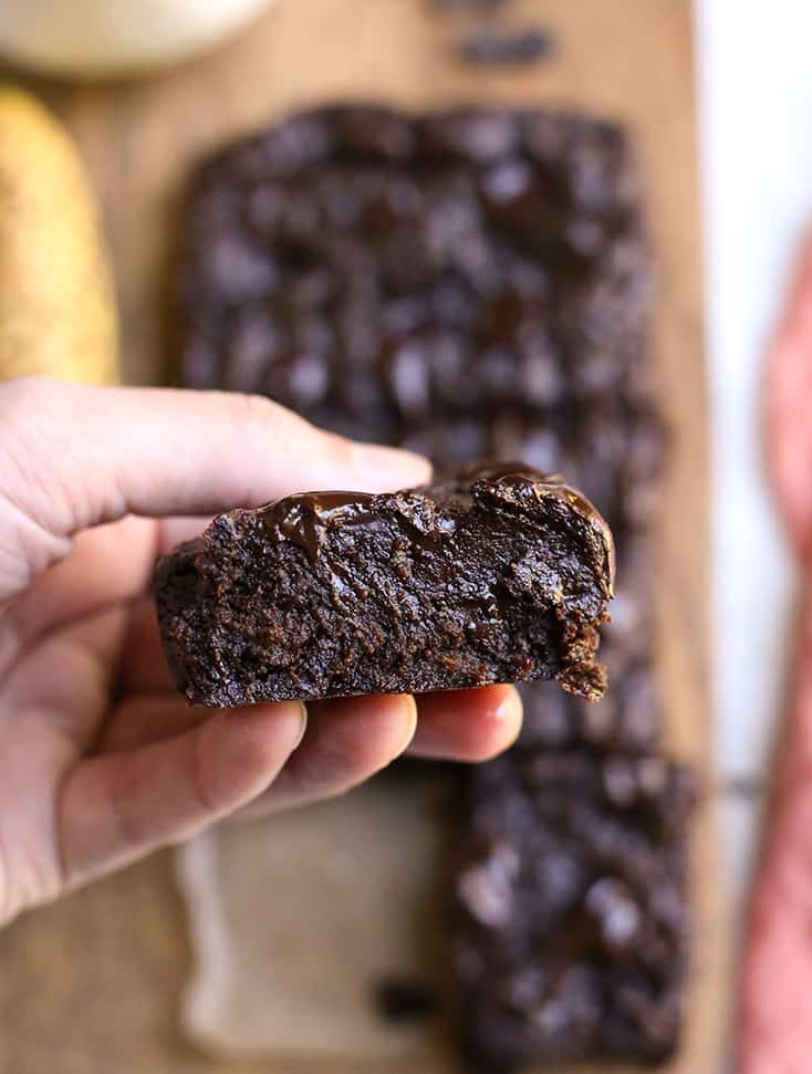 hand holding a paleo banana brownie showing the fudgy inside 