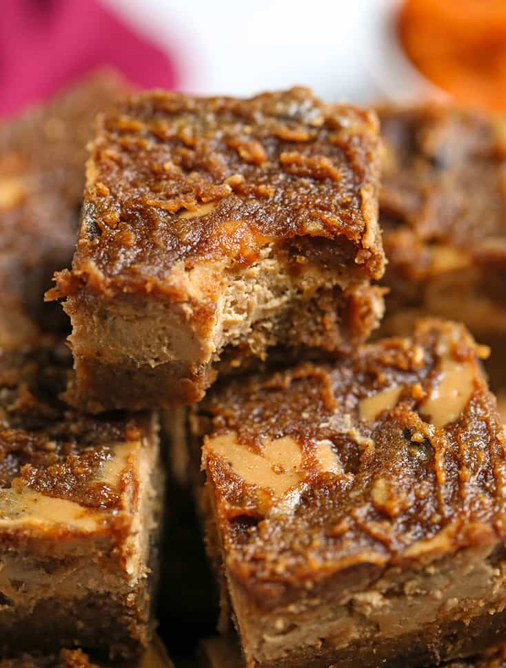 up close shot of a bite taken out of a pumpkin cheesecake bar