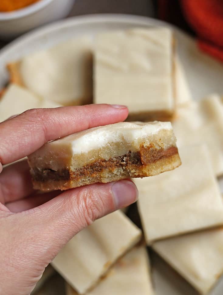 hand holding a paleo pumpkin pop tart bar with a bite taken out of it 