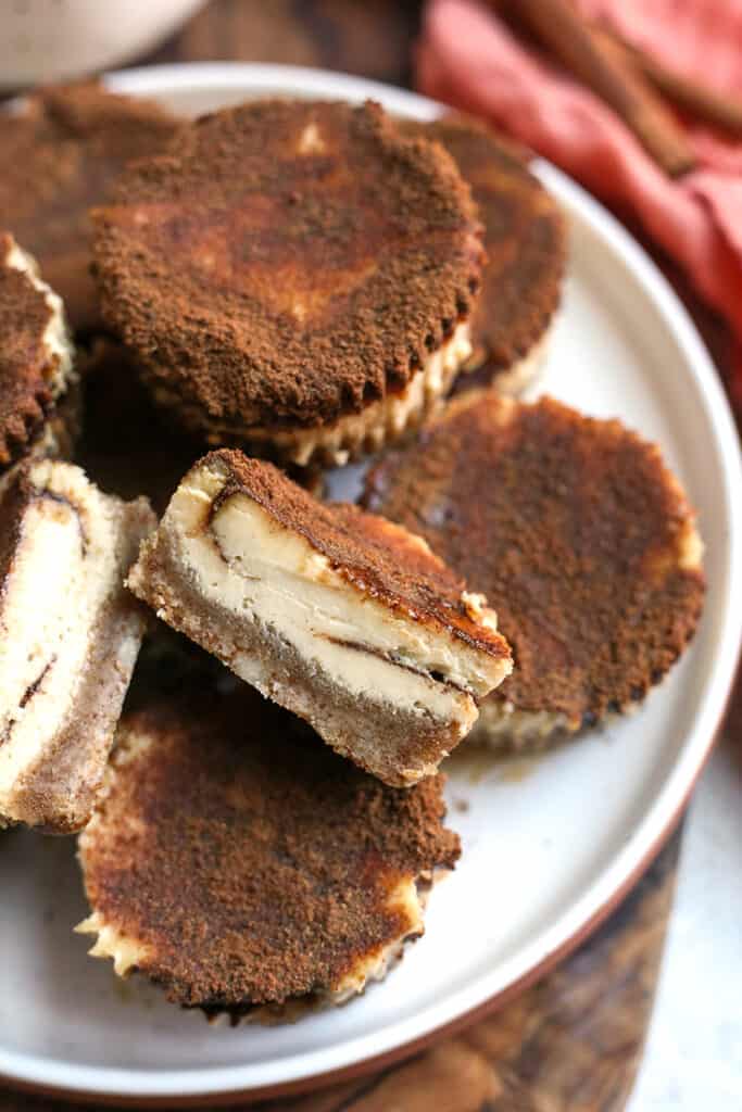 grain free cinnamon roll cheesecakes, one cut to show the layers 
