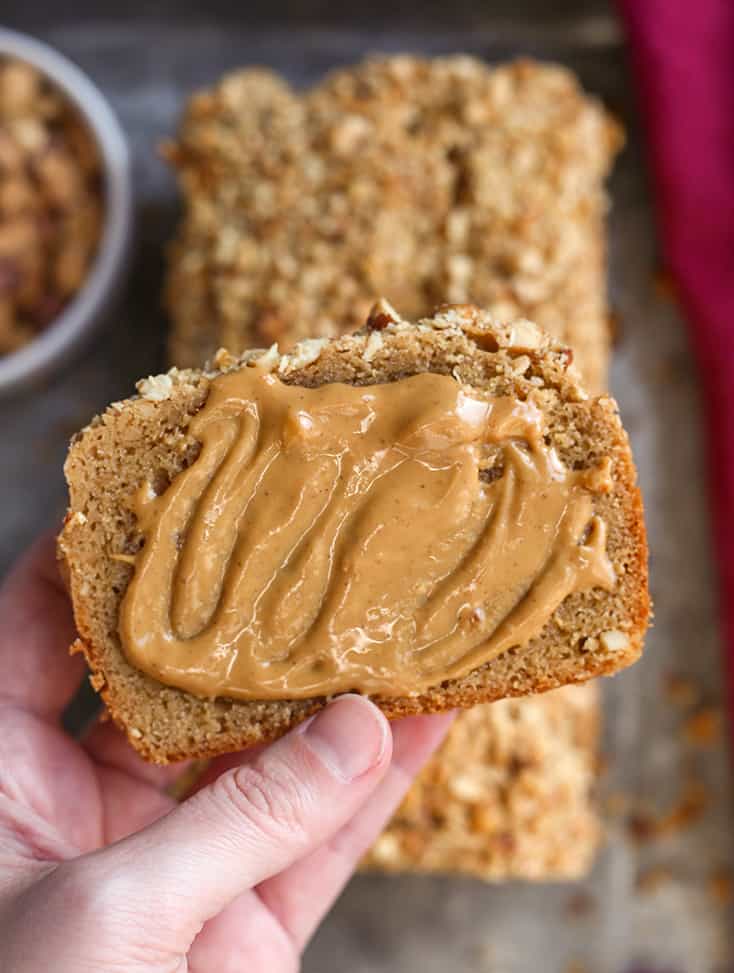 hand holding a piece of gluten free peanut butter bread 