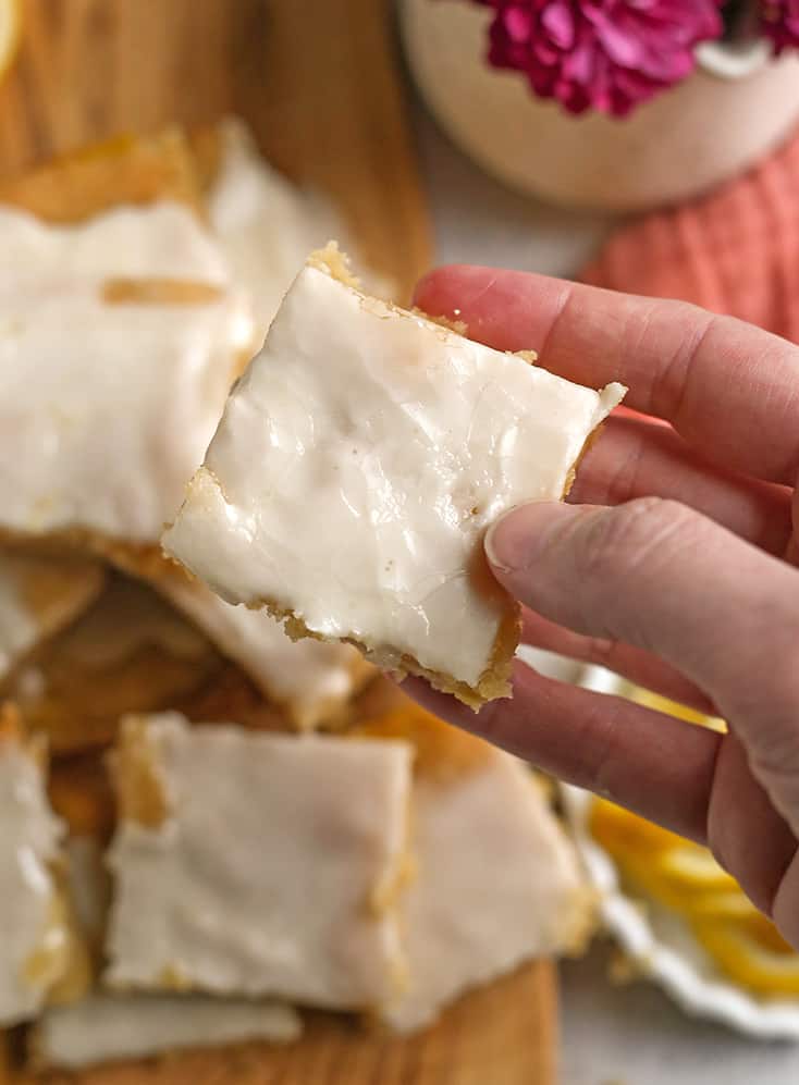 hand holding a lemon pop tart bar, showing the top glaze