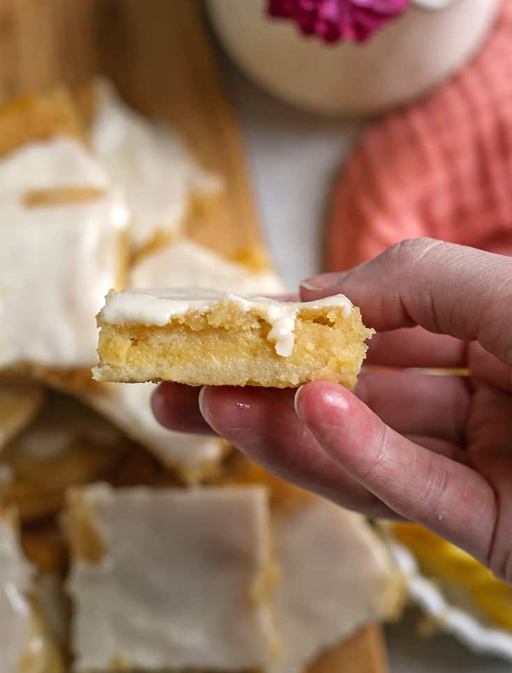 hand holding a lemon pop tart bar showing the layers 