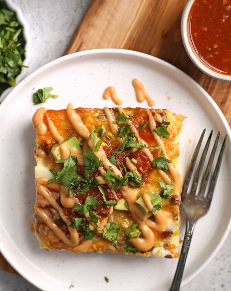 top view of Mexican egg bake showing the toppings of salsa, avocado and cilantro 