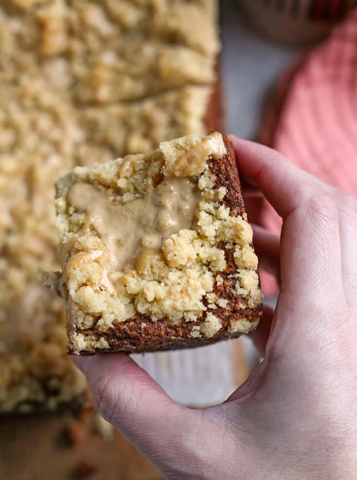 hand holding a piece of paleo coffee cake, showing the top crumb 