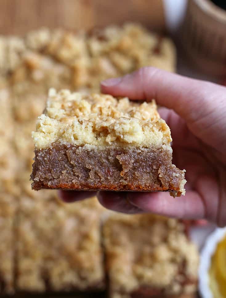 hand holding a piece of raspberry coffee cake